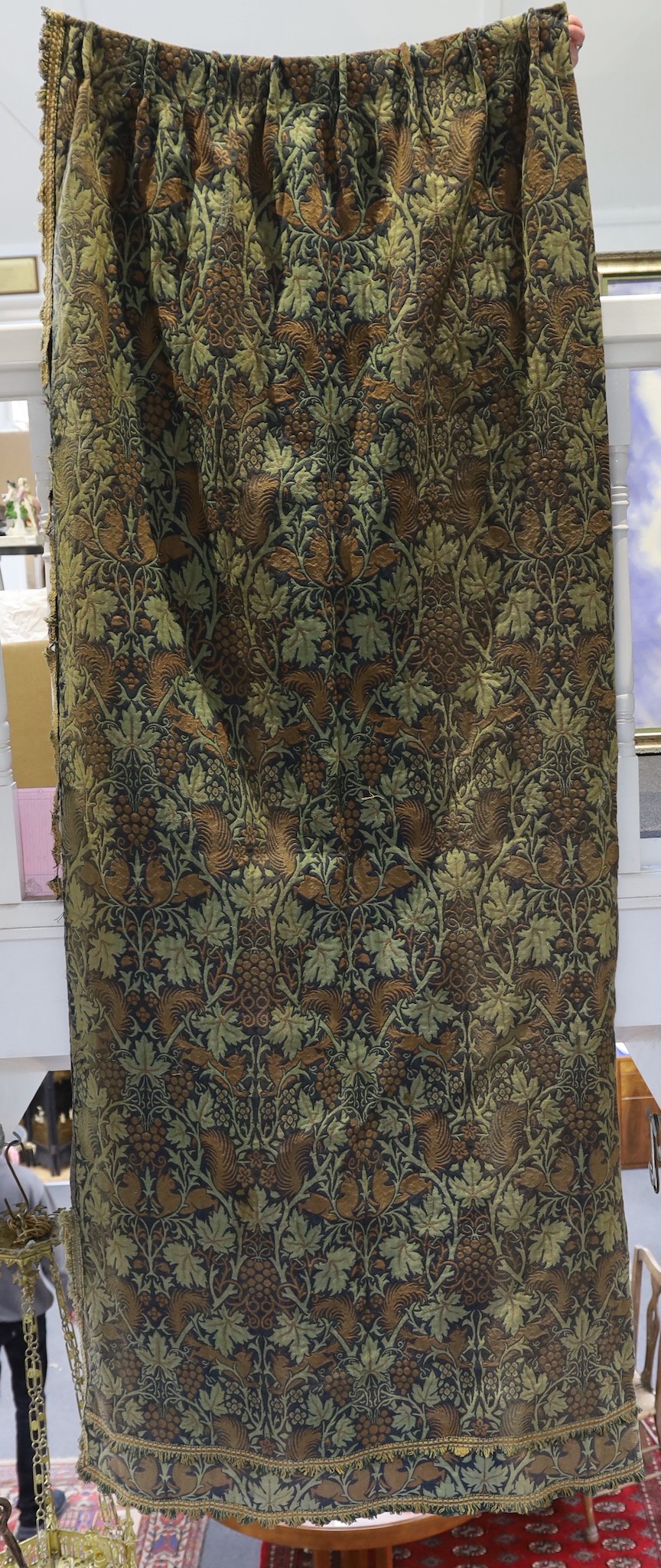 John Henry Dearle for Morris & Co. a pair of Squirrel design curtains, c.1890, hand loom woven wool at Merton Abbey, each with ornate braided edging and lining: 8ft 6ins. drop x 4ft wide each